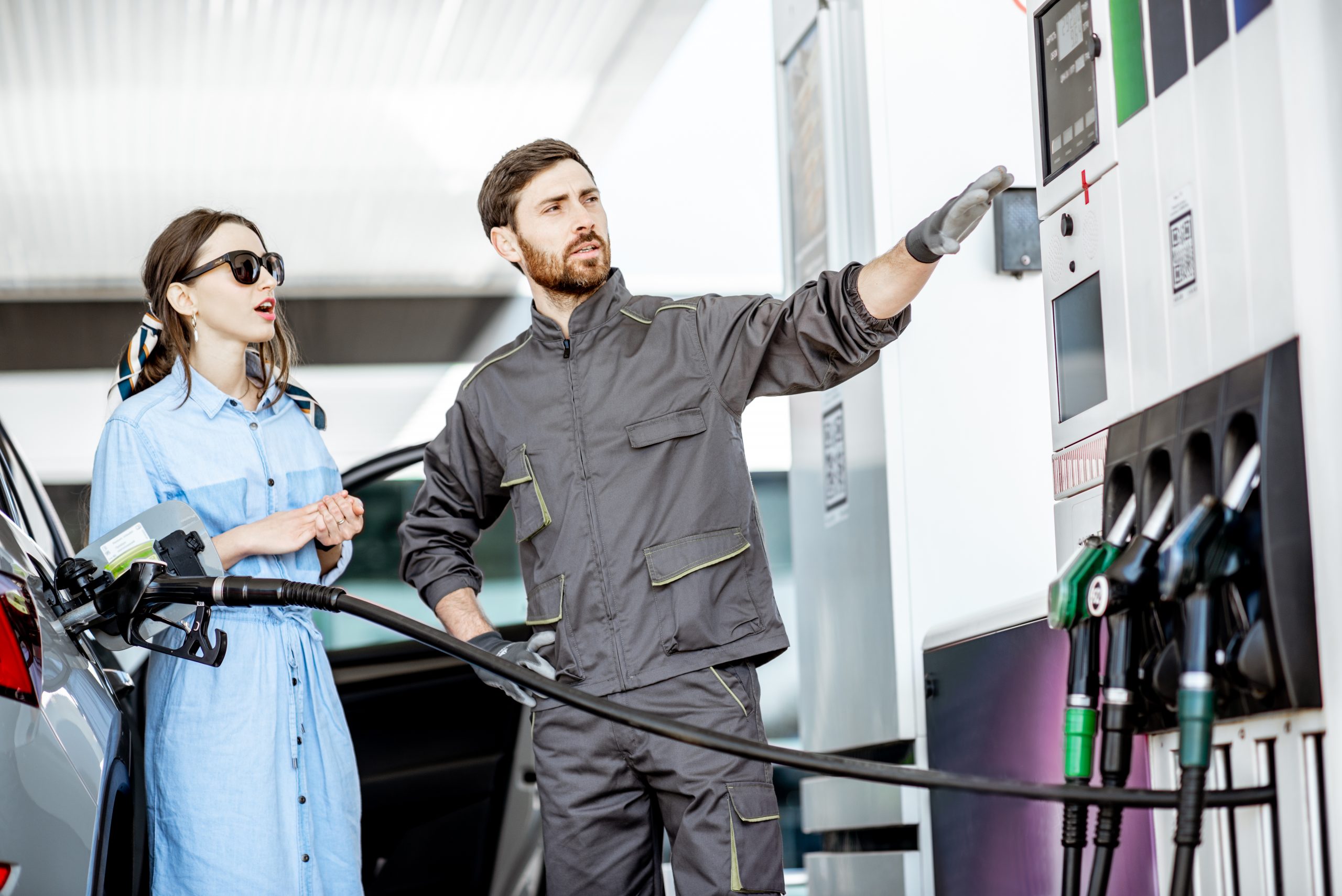Young,Woman,Client,With,Gas,Station,Worker,Refueling,Car,At