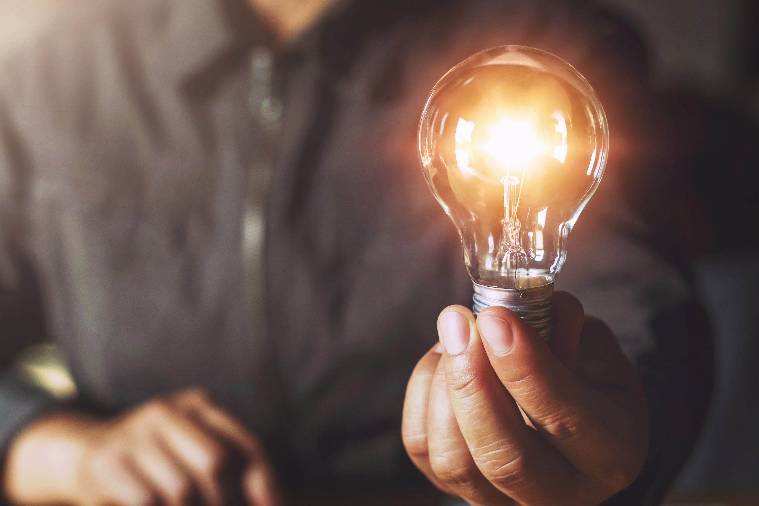 Hand,Holding,Light,Bulb.,Idea,Concept,With,Innovation,And,Inspiration